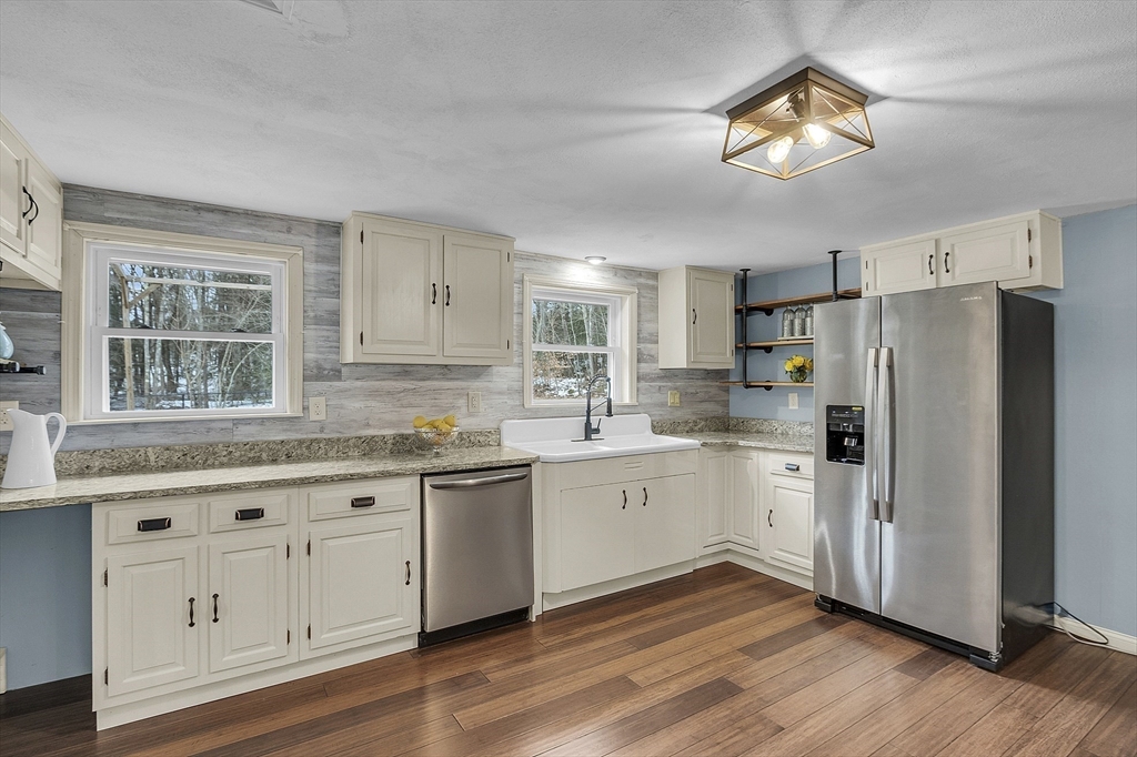 816 Patriots Road Templeton, MA 01468 - Photo 8 of 34 a kitchen with granite countertop white cabinets and white appliances