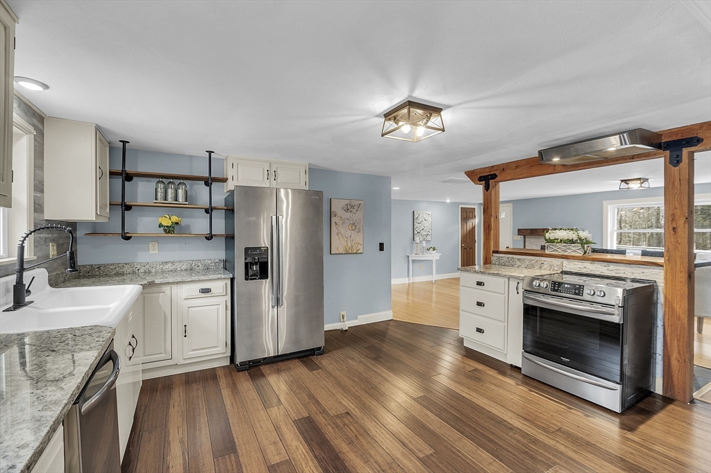 816 Patriots Road Templeton, MA 01468 - Photo 9 of 34 a kitchen with stainless steel appliances granite countertop a stove cabinets and wooden floor