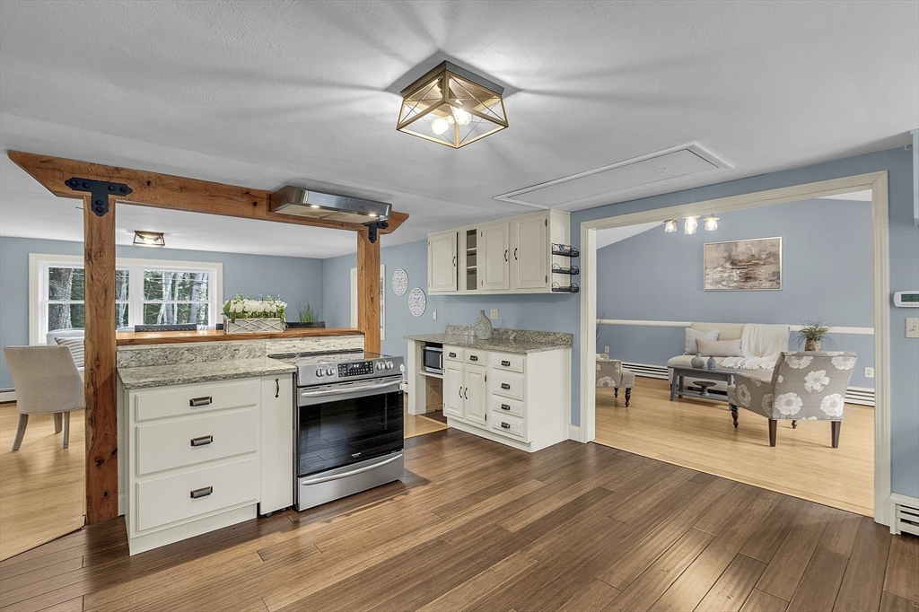 816 Patriots Road Templeton, MA 01468 - Photo 10 of 34 a kitchen with a stove cabinets and wooden floor