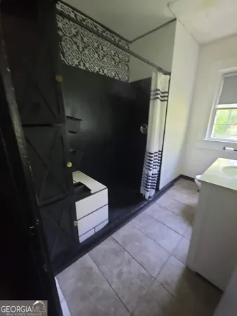 a room with wooden floor and a window