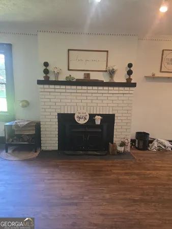 an empty room with windows and fireplace