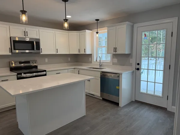 a kitchen with stainless steel appliances a sink stove and cabinets