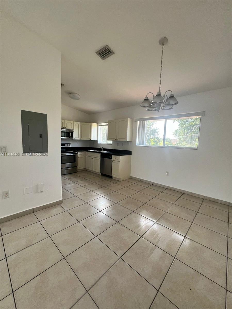 7281 Northwest 174th Terrace, Unit 204 Hialeah, FL 33015 - Photo 2 of 8 a view of a kitchen with a sink appliances and cabinets