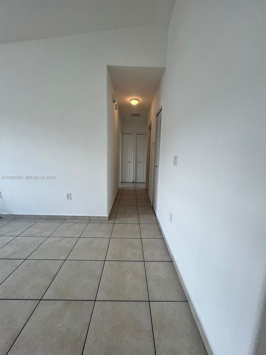 7281 Northwest 174th Terrace, Unit 204 Hialeah, FL 33015 - Photo 3 of 8 a view of an empty room