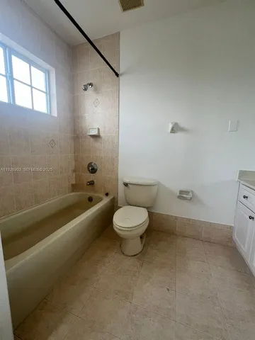 a bathroom with a toilet a sink and a bathtub