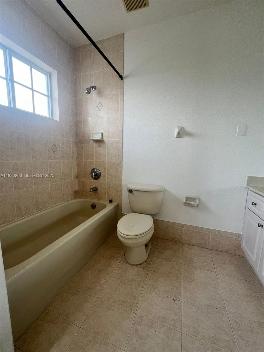 7281 Northwest 174th Terrace, Unit 204 Hialeah, FL 33015 - Photo 5 of 8 a bathroom with a toilet a sink and a bathtub