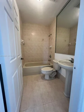 a bathroom with a toilet a sink and bathtub