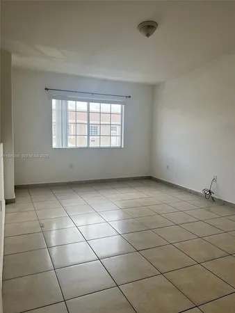 an empty room with a empty space and a window