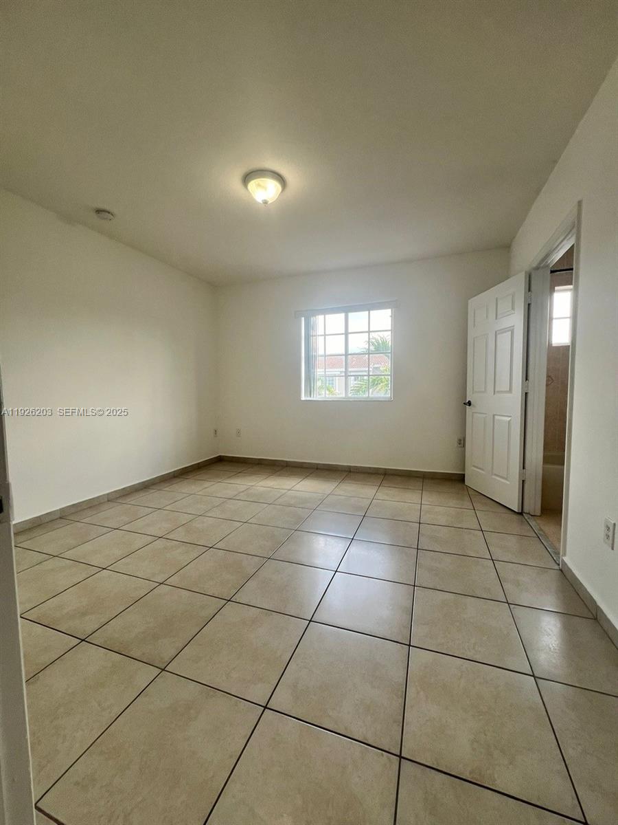 7281 Northwest 174th Terrace, Unit 204 Hialeah, FL 33015 - Photo 8 of 8 a view of an empty room and window