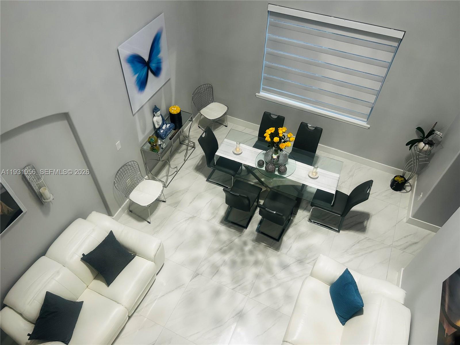 13995 Southwest 154th Street Miami, FL 33177 - Photo 12 of 27 a living room with furniture and a painting on the wall