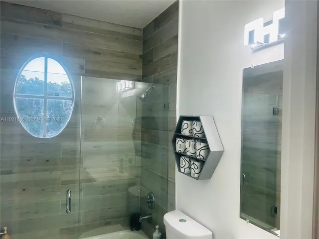 a bathroom with a toilet and a shower