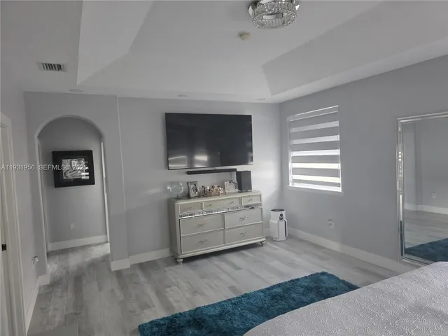 a room with a bed and a flat screen tv