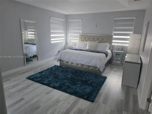 a bed sitting in a bedroom next to a window