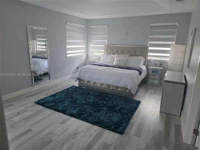 a bed sitting in a bedroom next to a window