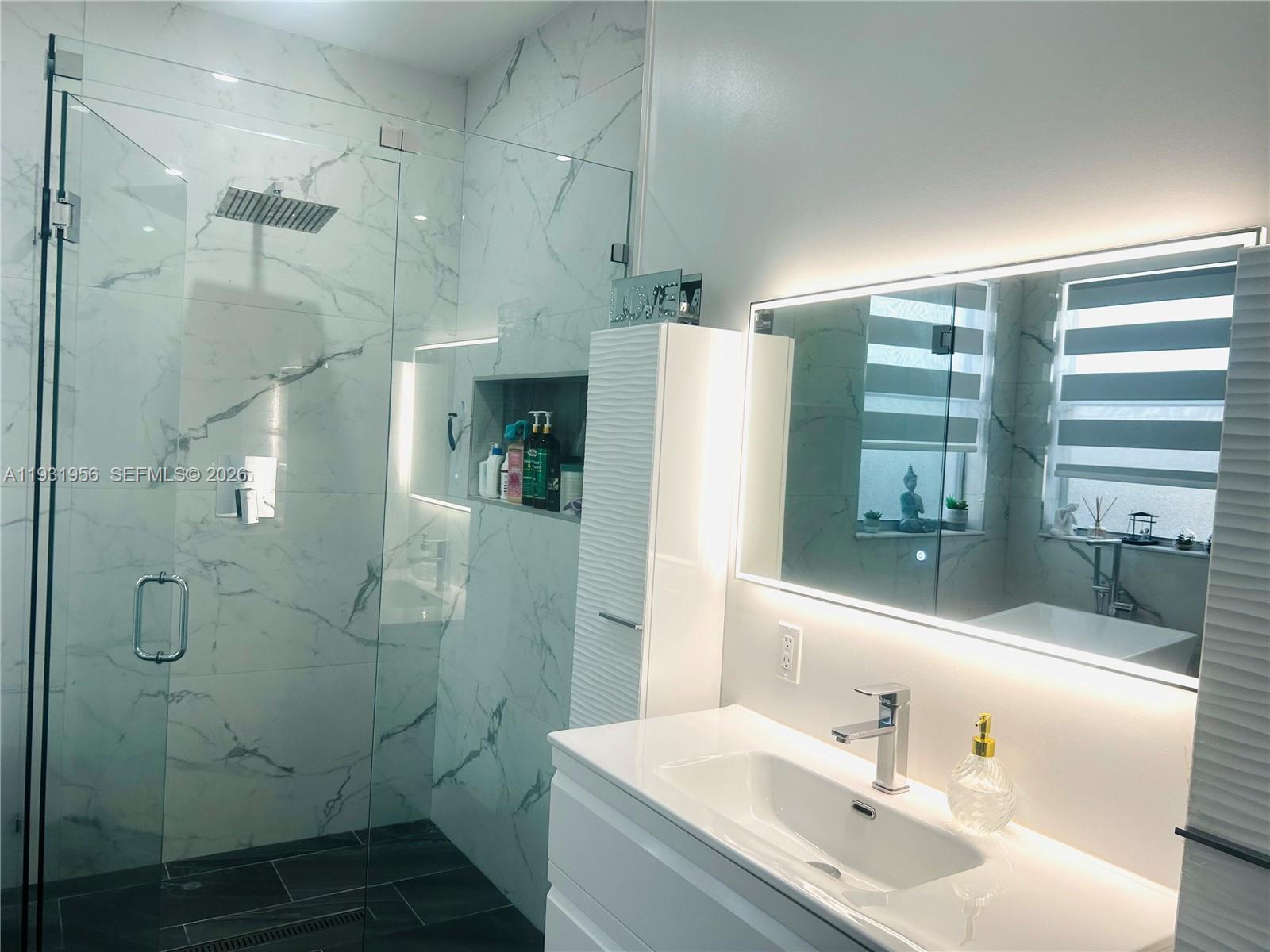 13995 Southwest 154th Street Miami, FL 33177 - Photo 20 of 27 a bathroom with a sink shower and a mirror