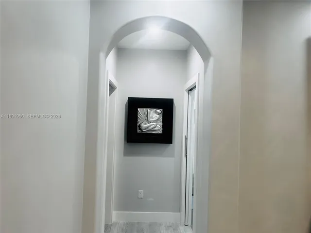 a bathroom with a sink shower and a mirror