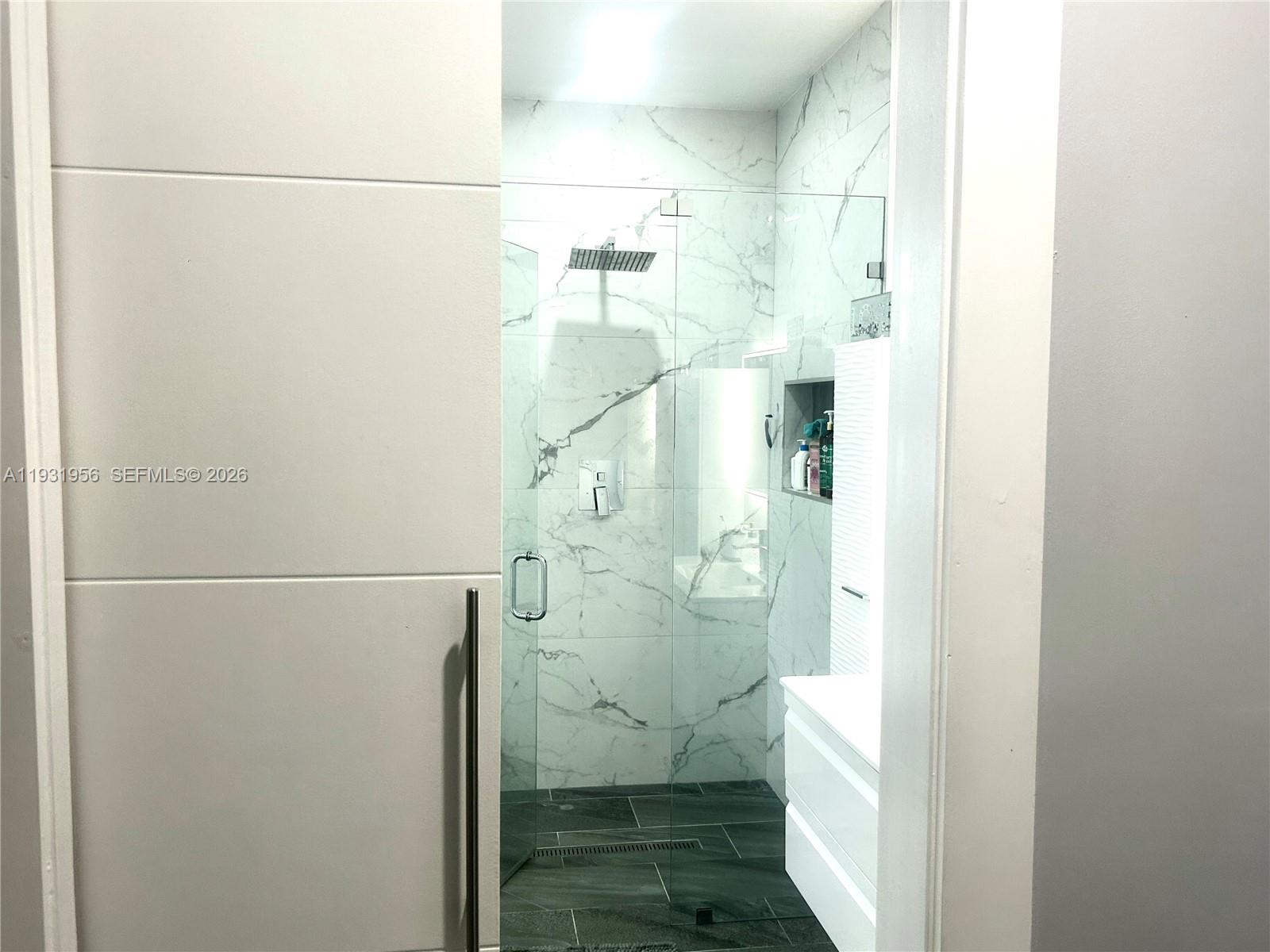 13995 Southwest 154th Street Miami, FL 33177 - Photo 22 of 27 a bathroom with a glass shower door
