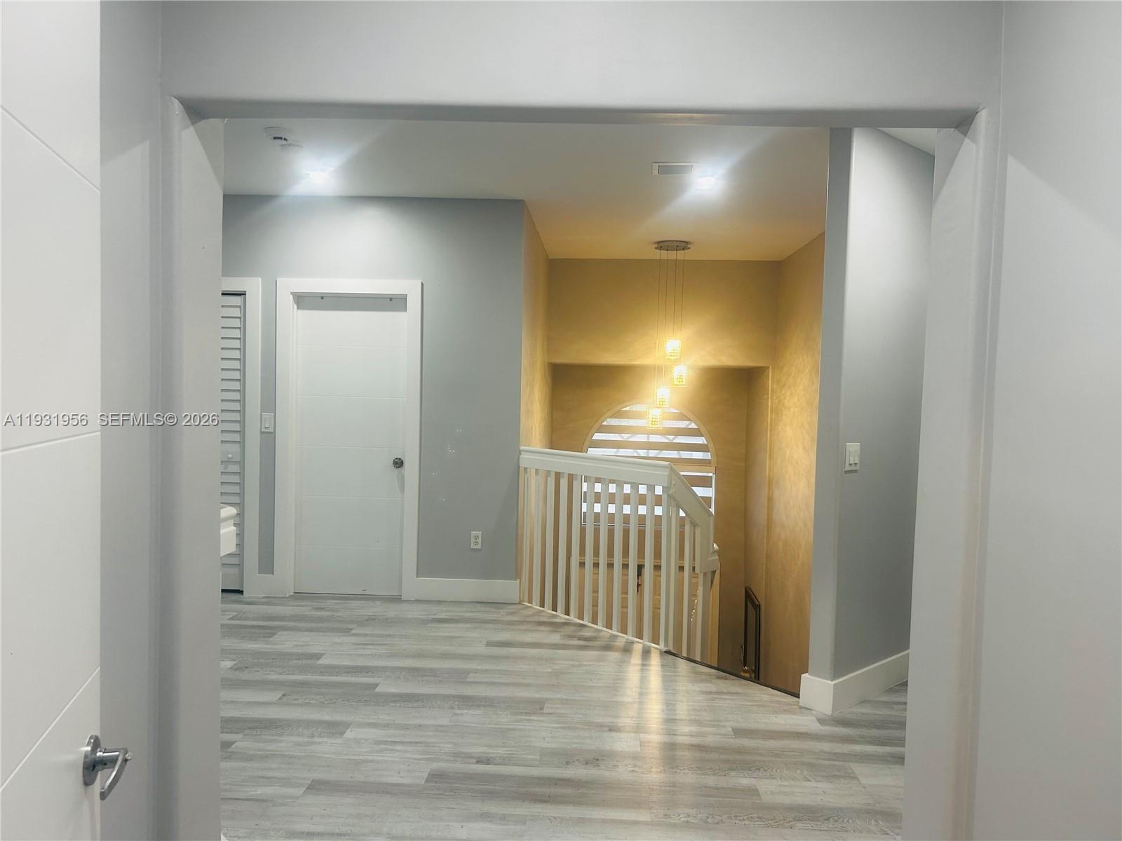 13995 Southwest 154th Street Miami, FL 33177 - Photo 24 of 27 a view of a hallway with wooden floor