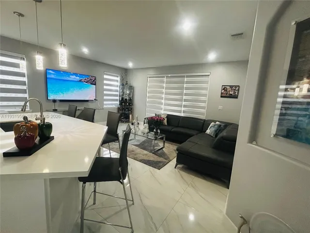 a living room with furniture a rug and a flat screen tv