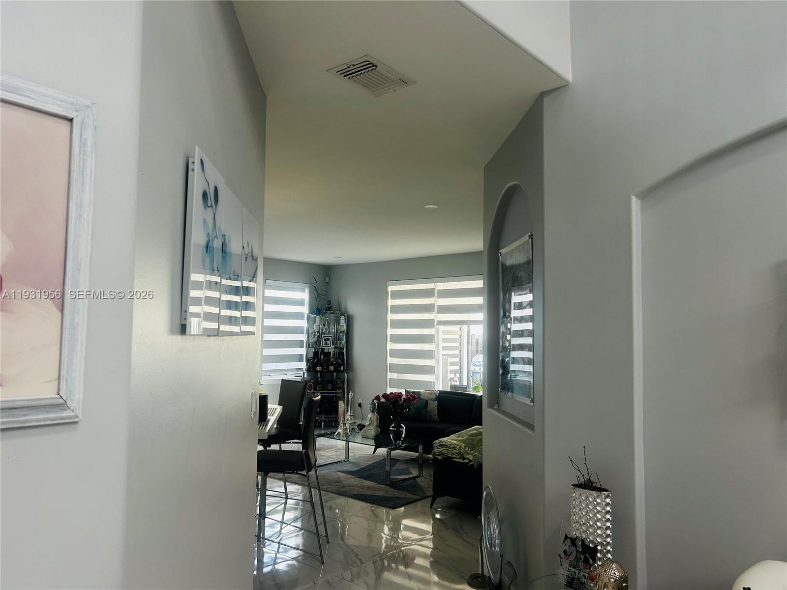13995 Southwest 154th Street Miami, FL 33177 - Photo 7 of 27 a living room with furniture and a window