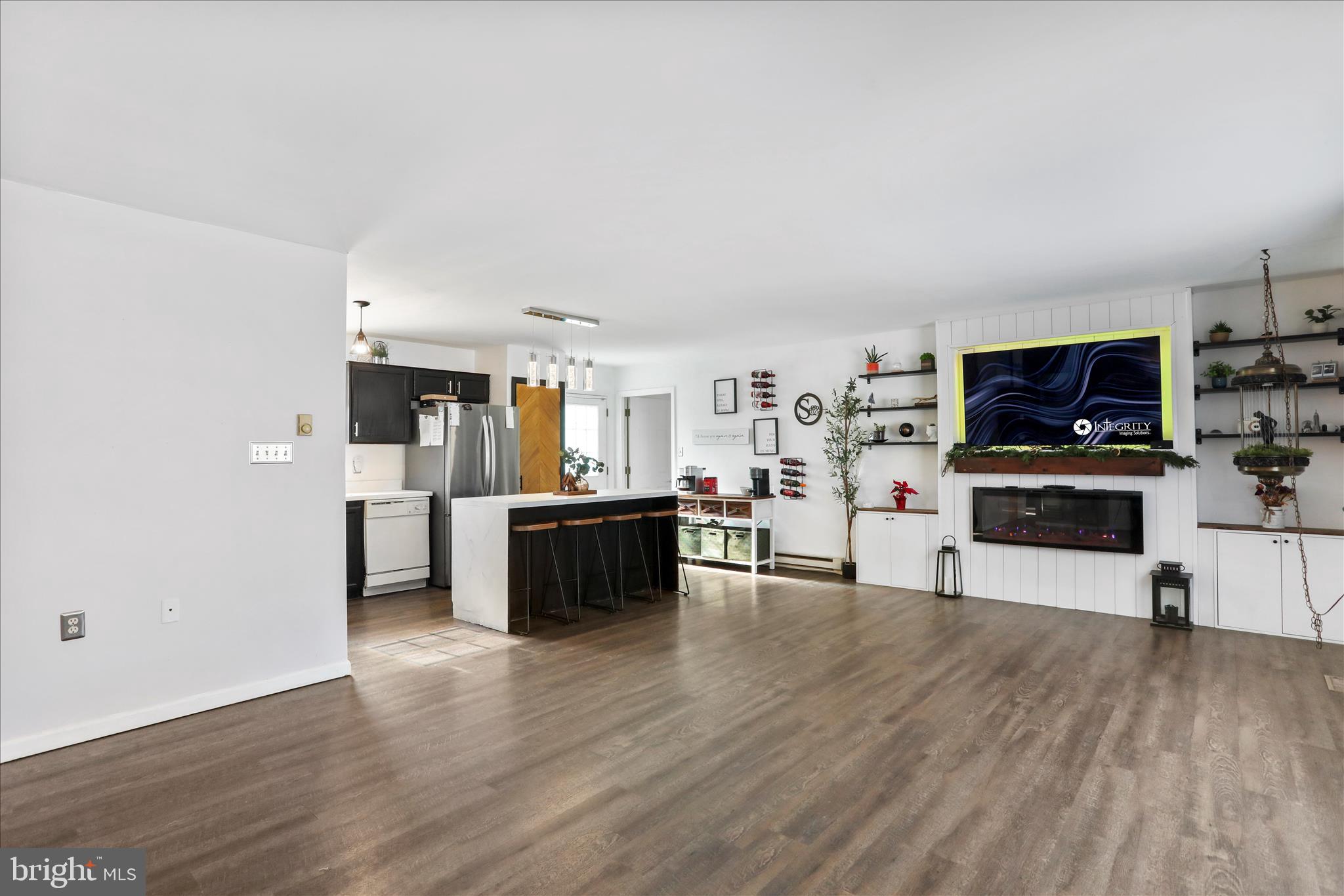 2828 Falling Spring Road Chambersburg, PA 17202 - Photo 5 of 26 a living room with stainless steel appliances kitchen island granite countertop a stove top oven a sink dishwasher and a fireplace with wooden floor