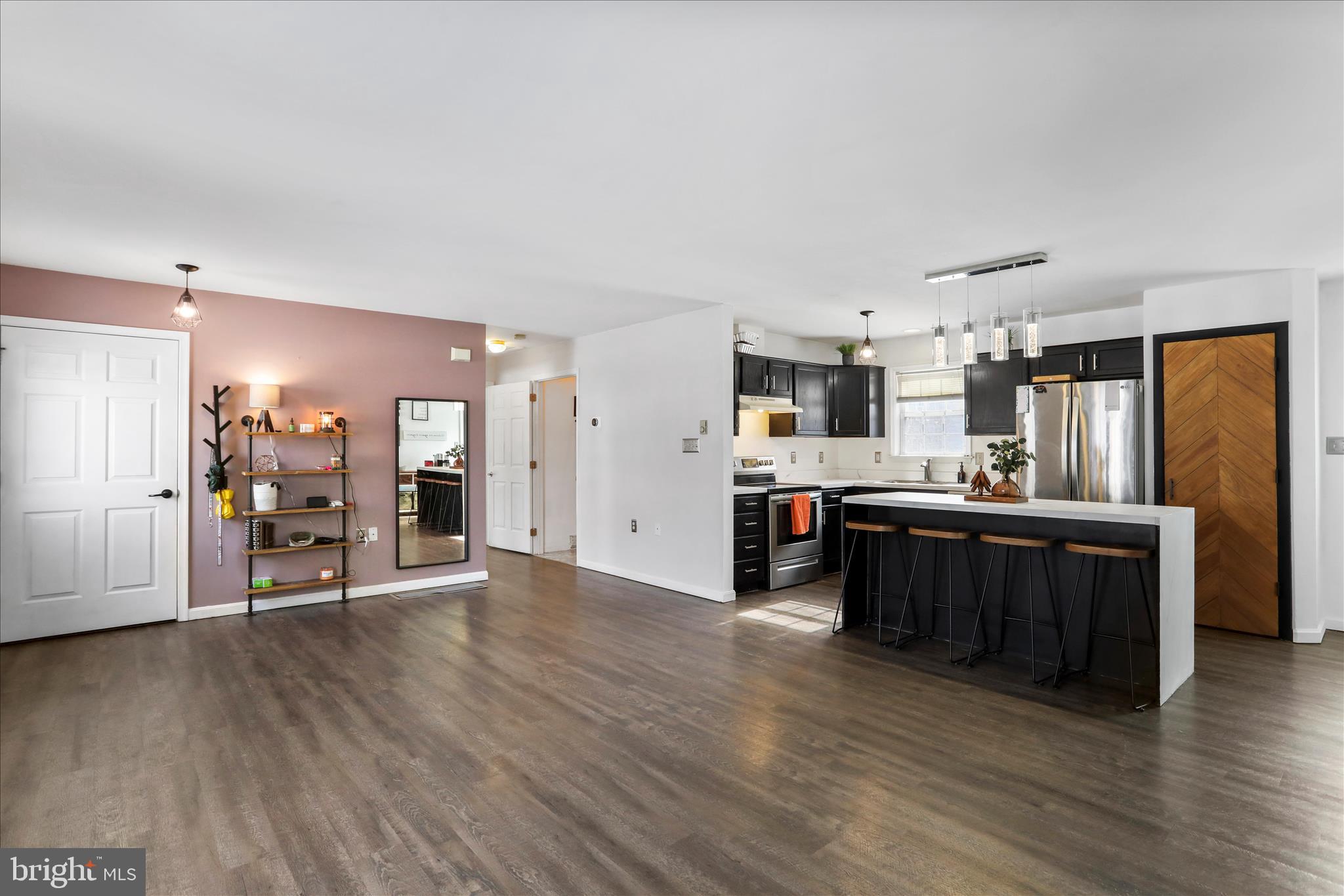 2828 Falling Spring Road Chambersburg, PA 17202 - Photo 7 of 26 a view of a kitchen with stainless steel appliances wooden floor and chair