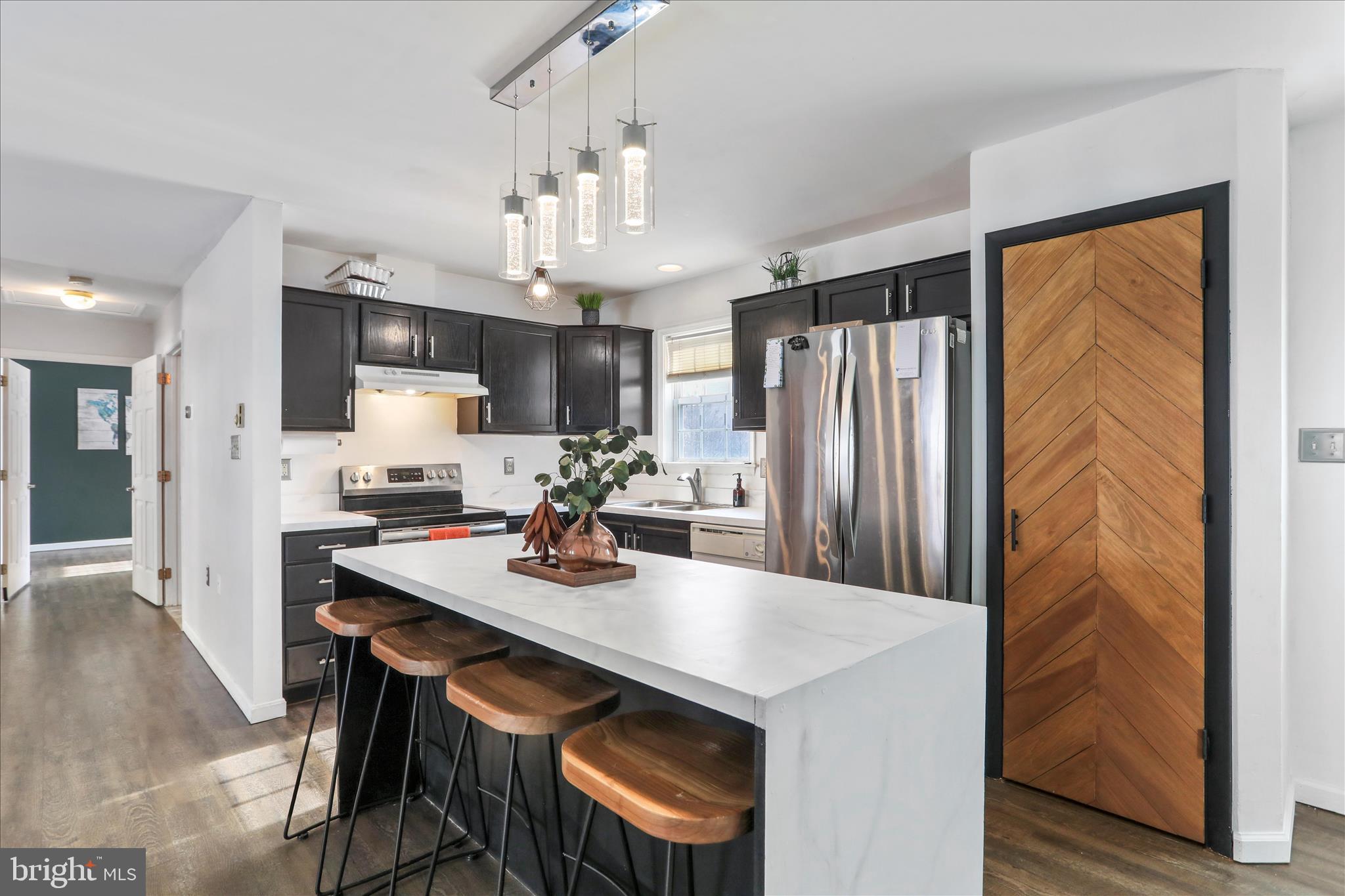 2828 Falling Spring Road Chambersburg, PA 17202 - Photo 9 of 26 a kitchen with stainless steel appliances granite countertop a sink refrigerator and cabinets