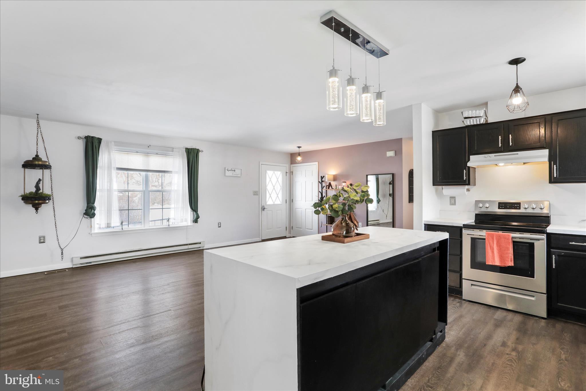 2828 Falling Spring Road Chambersburg, PA 17202 - Photo 10 of 26 a kitchen with stainless steel appliances granite countertop a sink stove and wooden floor