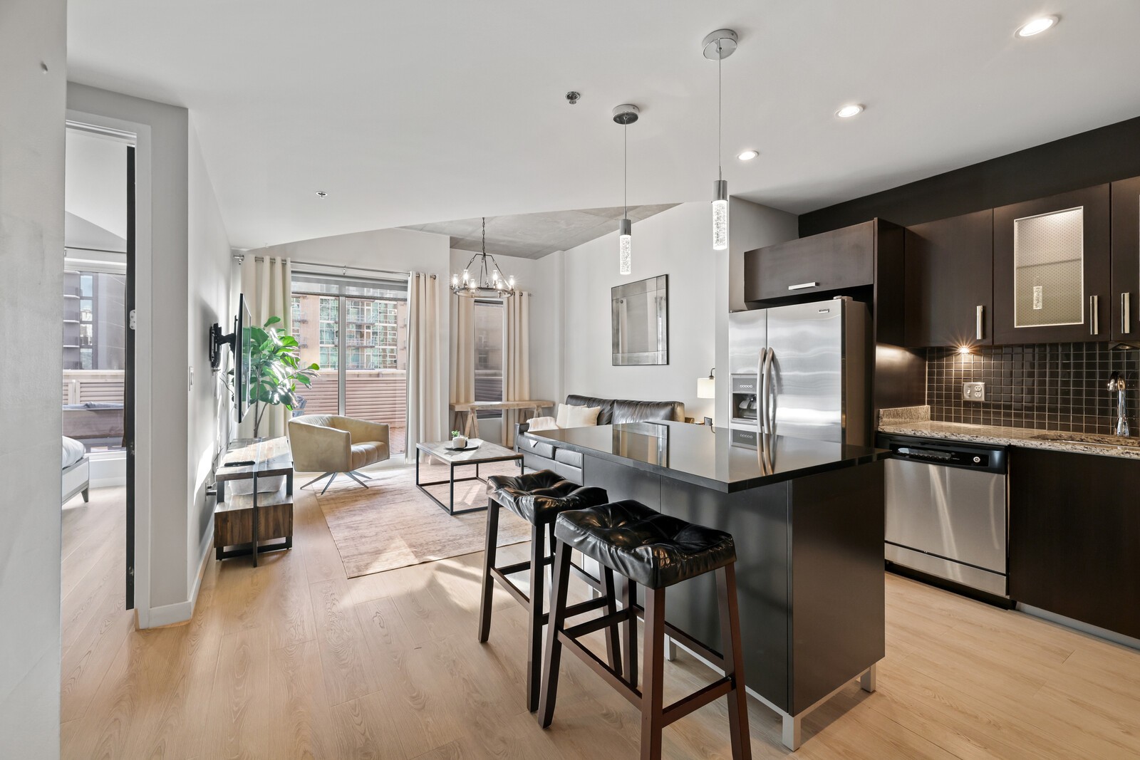 600 12th Avenue South, Unit 910 Nashville, TN 37203 - Photo 1 of 15 a kitchen with stainless steel appliances kitchen island granite countertop a table chairs sink and cabinets