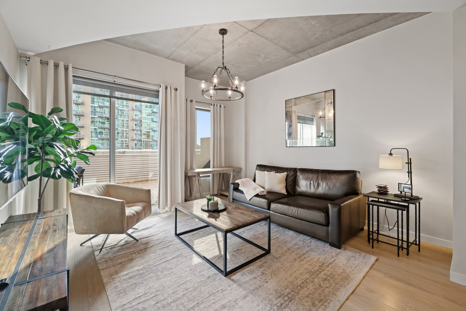 600 12th Avenue South, Unit 910 Nashville, TN 37203 - Photo 2 of 15 a living room with furniture and a window