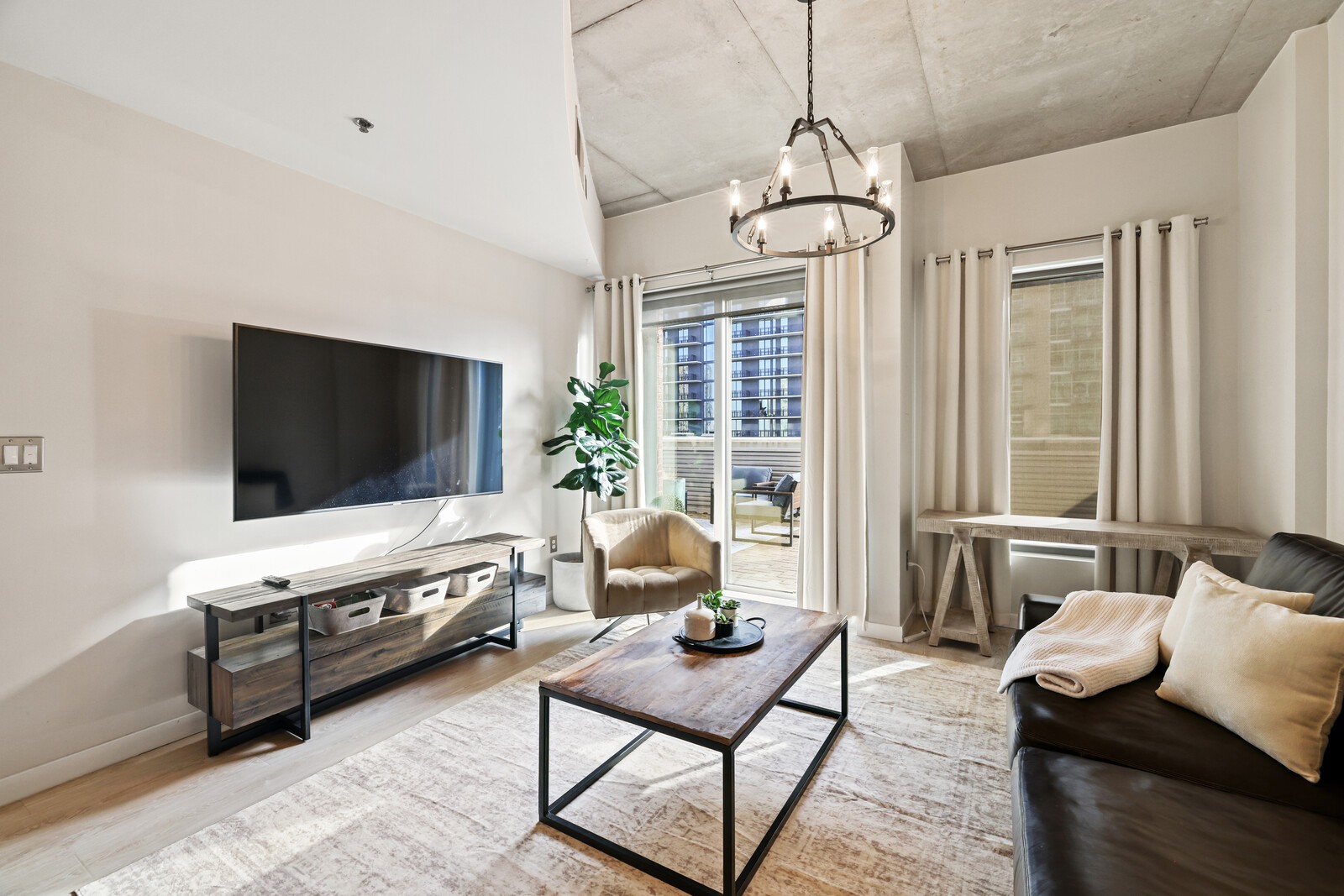 600 12th Avenue South, Unit 910 Nashville, TN 37203 - Photo 4 of 15 a living room with furniture and a flat screen tv