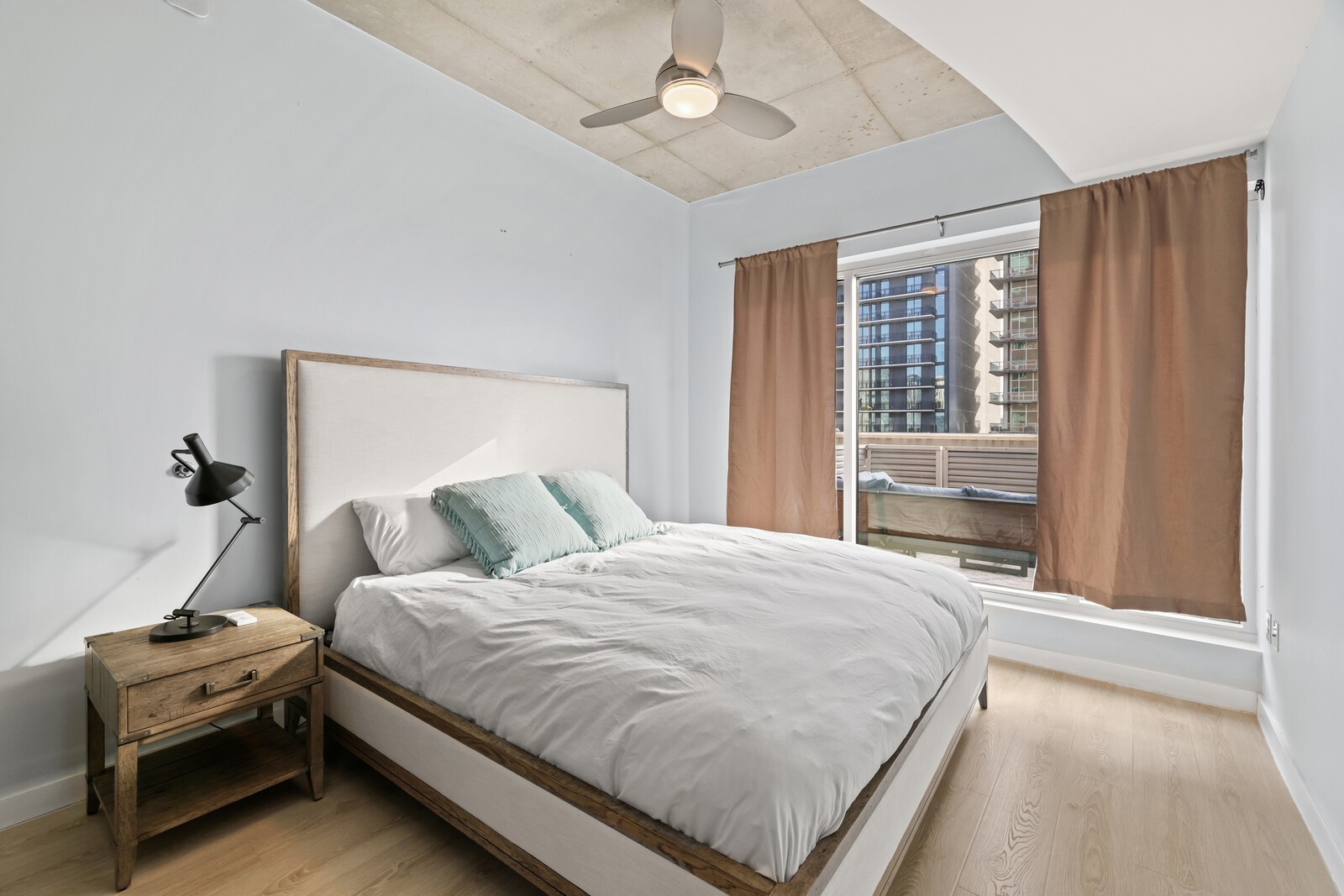 600 12th Avenue South, Unit 910 Nashville, TN 37203 - Photo 6 of 15 a bedroom with a bed and a window