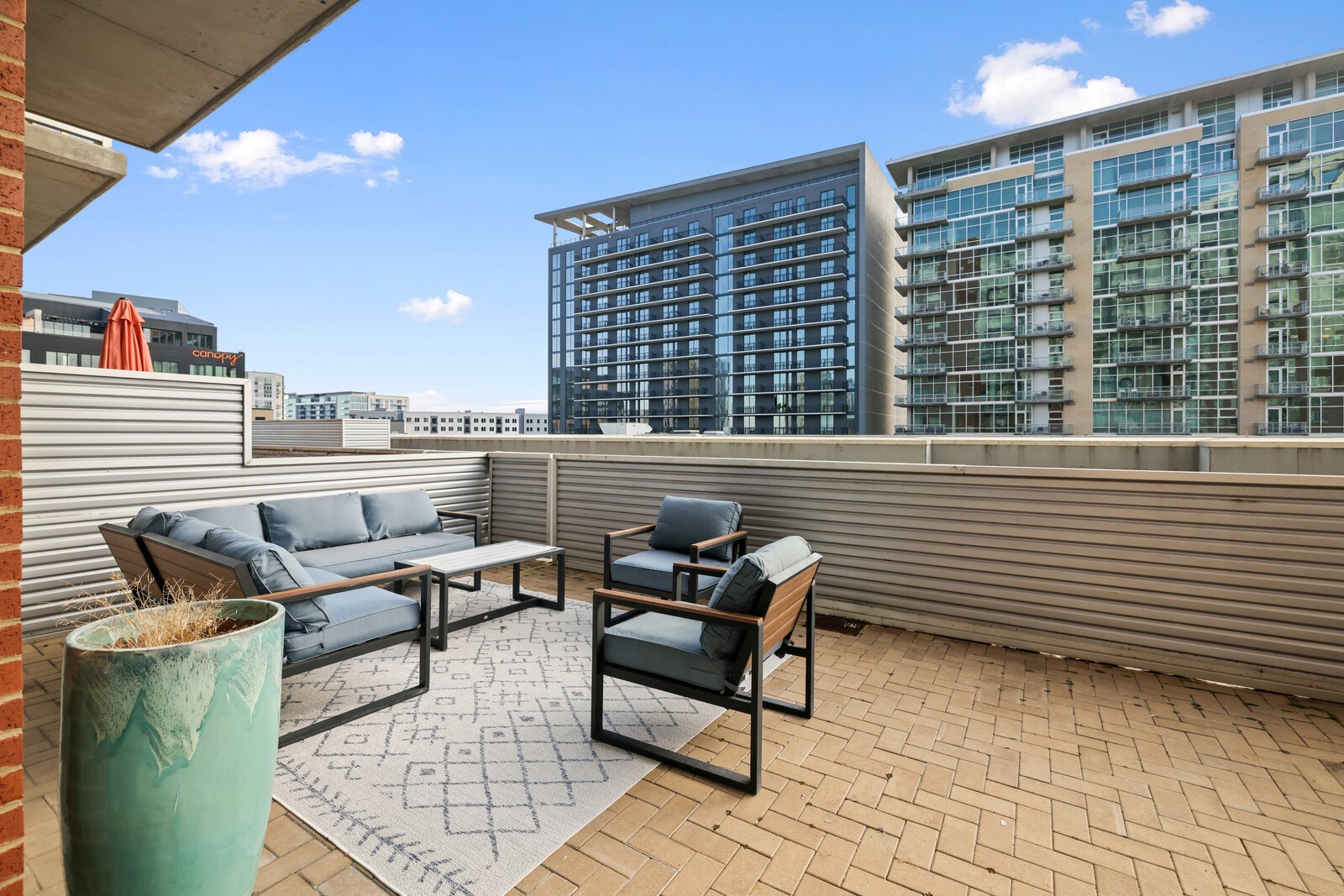 600 12th Avenue South, Unit 910 Nashville, TN 37203 - Photo 8 of 15 a roof deck with couch and chairs