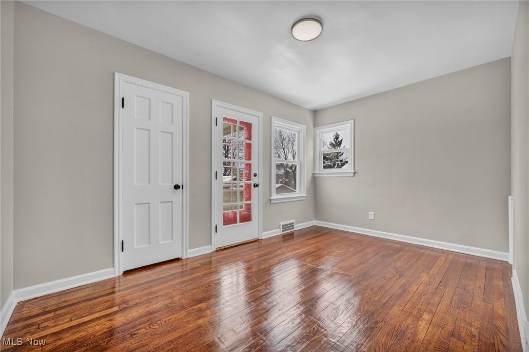13614 Cedar Road Cleveland, OH 44118 - Photo 28 of 46 Unfurnished room with visible vents, baseboards, and wood finished floors