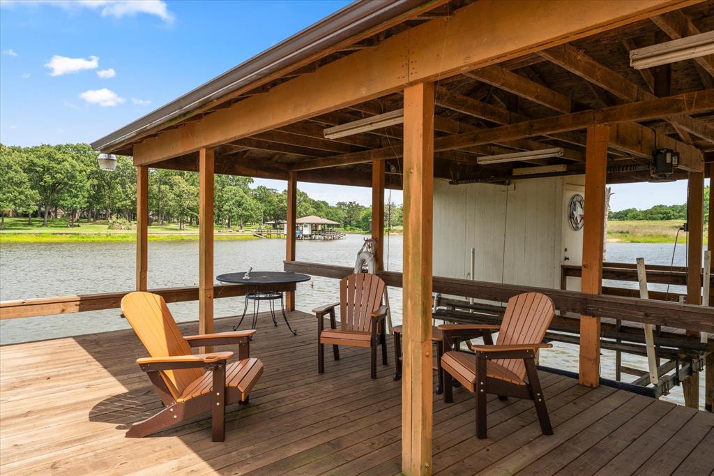345 Rains County Road 3390 Emory, TX 75440 - Photo 34 of 39 a patio with lawn chairs and wooden floor