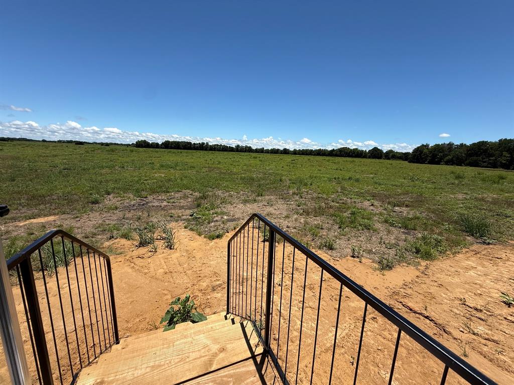 0 Southeast 4060 Road, Unit 25 Kerens, TX 75144 - Photo 16 of 18 Expansive land parcel featuring natural ground cover, a tree line horizon, and clear sky