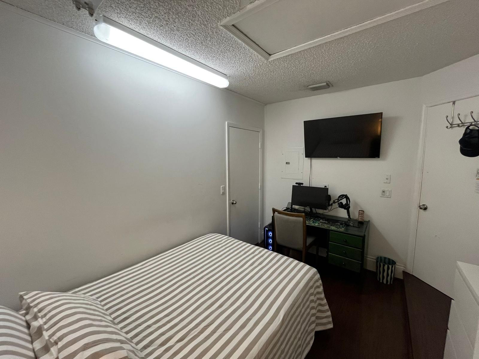 20780 Boca Ridge Drive North, Unit 20780 Boca Raton, FL 33428 - Photo 21 of 35 a bedroom with a bed and a flat screen tv