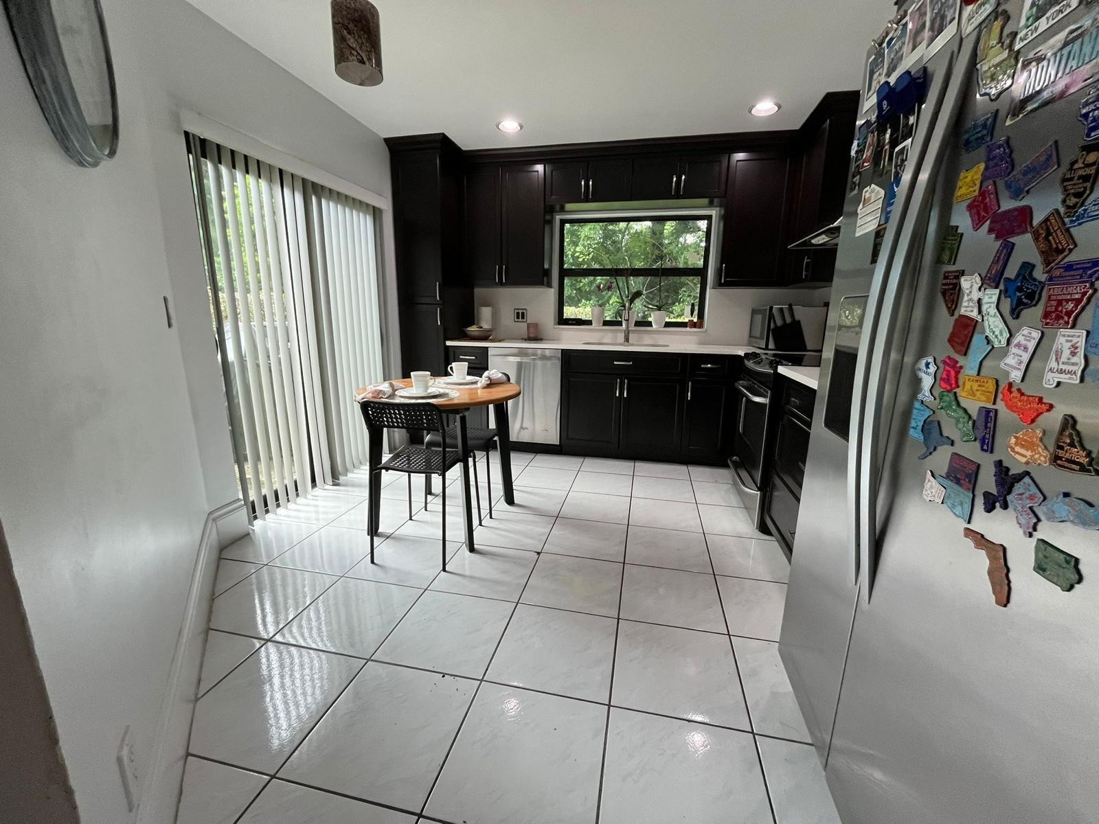 20780 Boca Ridge Drive North, Unit 20780 Boca Raton, FL 33428 - Photo 22 of 35 a kitchen with stainless steel appliances granite countertop a refrigerator and a sink