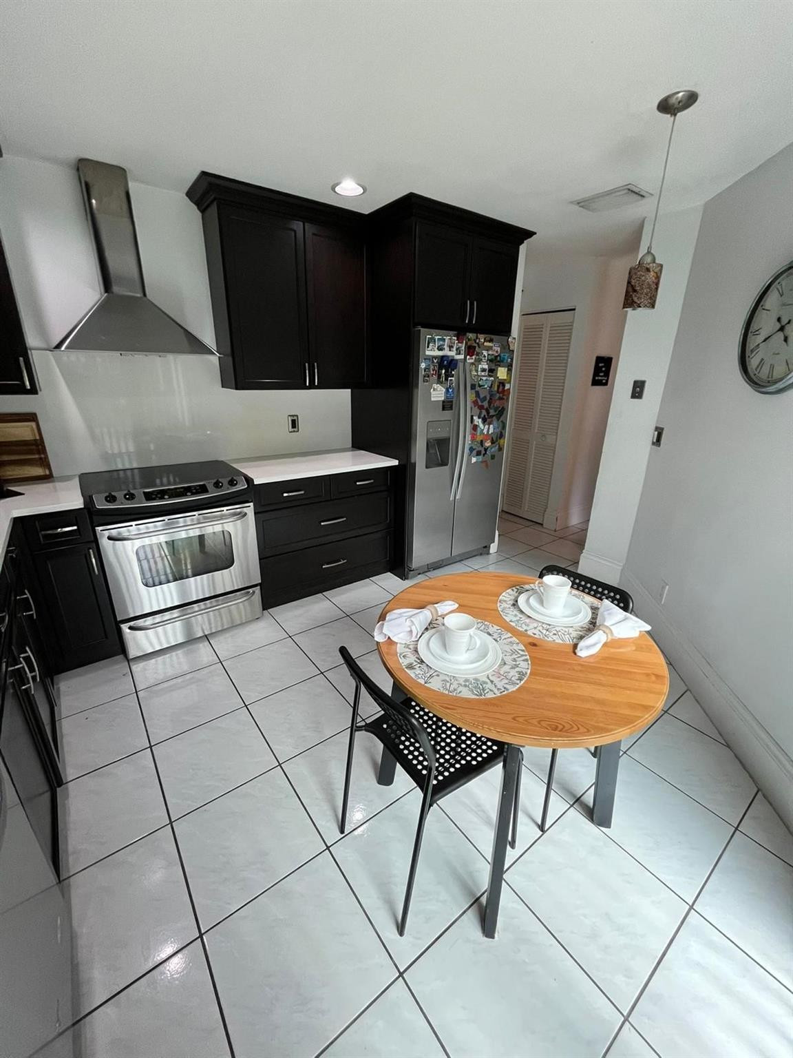 20780 Boca Ridge Drive North, Unit 20780 Boca Raton, FL 33428 - Photo 23 of 35 a kitchen with stainless steel appliances a sink a stove a microwave a refrigerator and cabinets