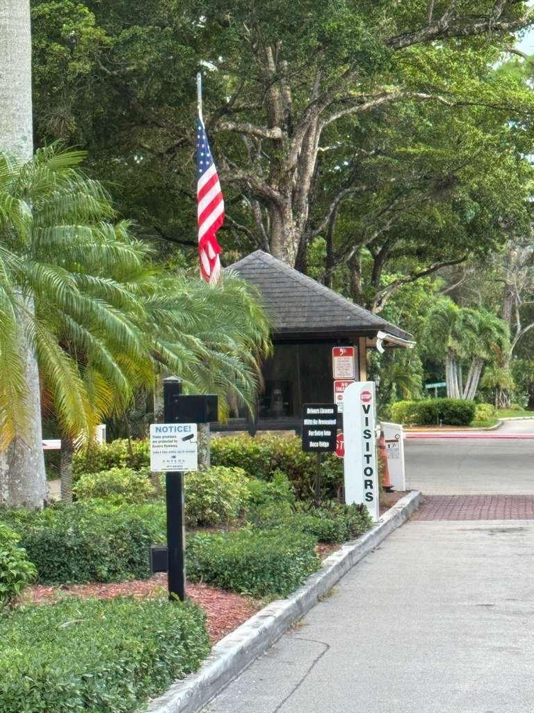 20780 Boca Ridge Drive North, Unit 20780 Boca Raton, FL 33428 - Photo 31 of 35 a front view of a house with a yard and fountain
