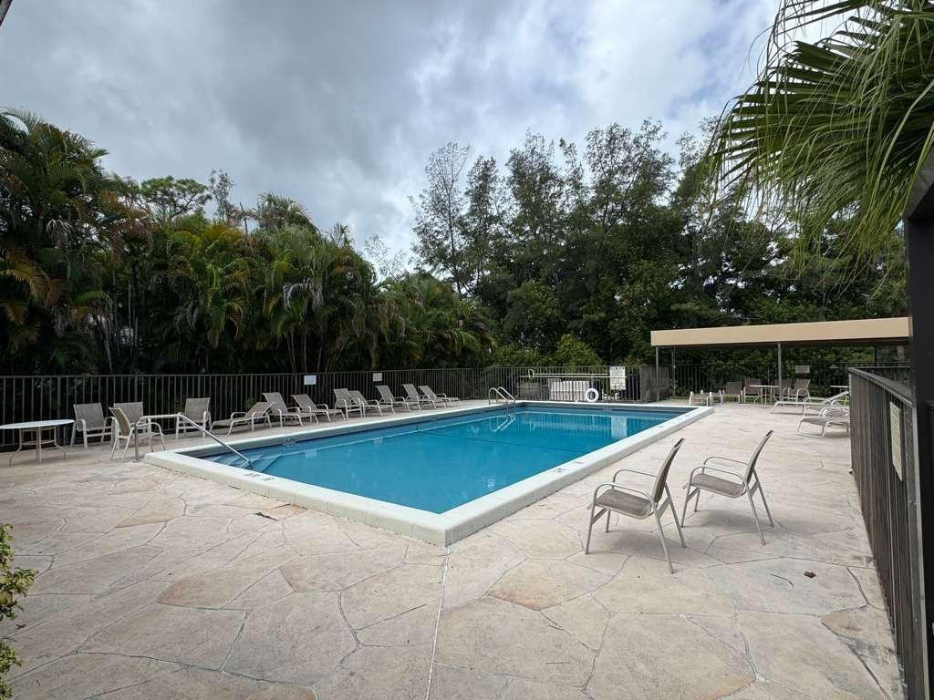 20780 Boca Ridge Drive North, Unit 20780 Boca Raton, FL 33428 - Photo 32 of 35 a view of backyard with swimming pool and seating