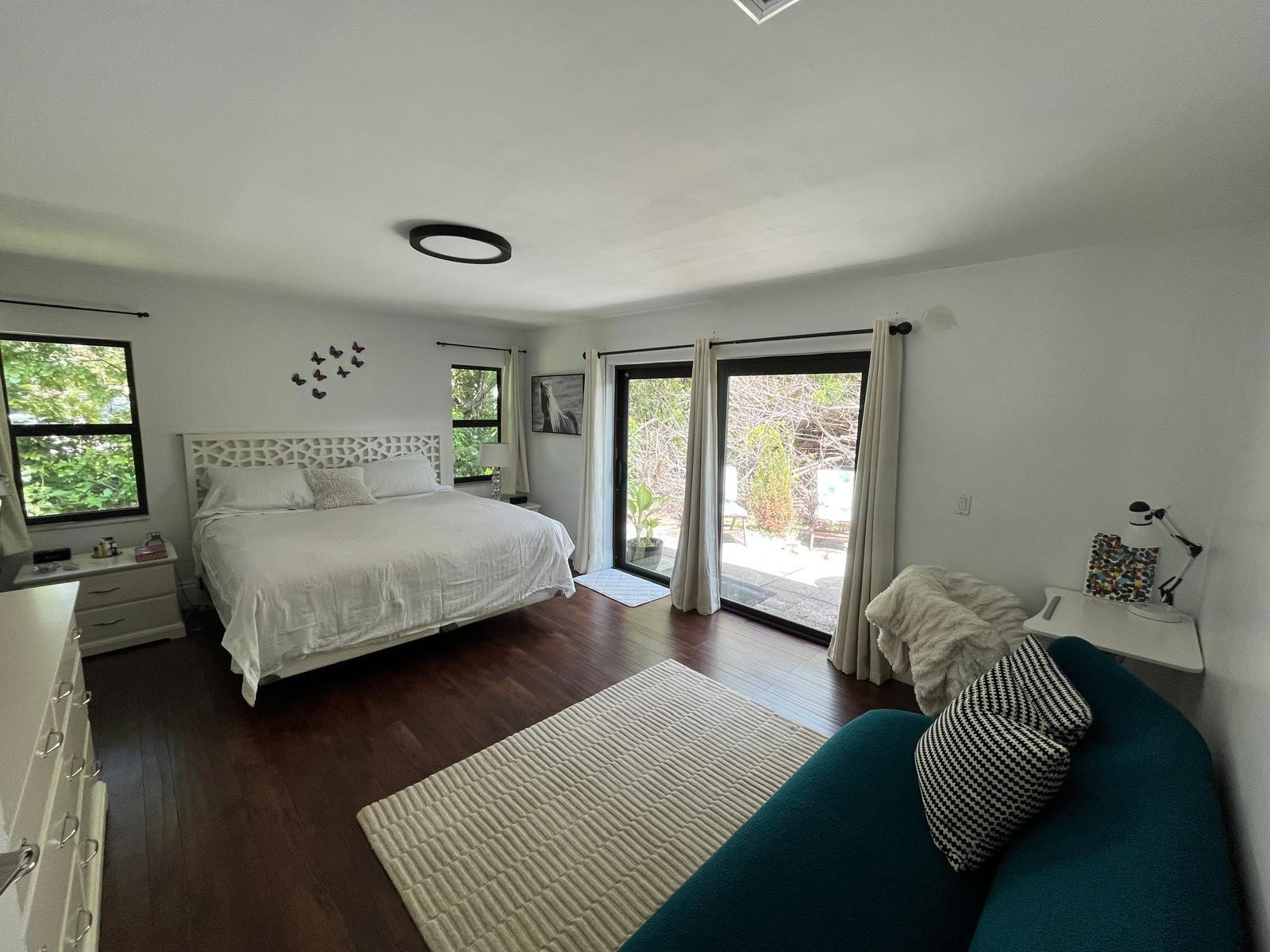 20780 Boca Ridge Drive North, Unit 20780 Boca Raton, FL 33428 - Photo 8 of 35 a bedroom with a bed and wooden floor