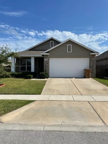 a front view of house along with road and green space