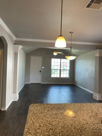 a view of a kitchen with a chandelier and wooden floor