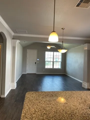 a view of a kitchen with a chandelier and wooden floor