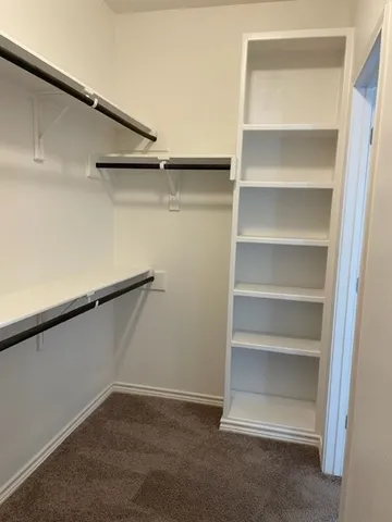 a view of an empty walk in closet