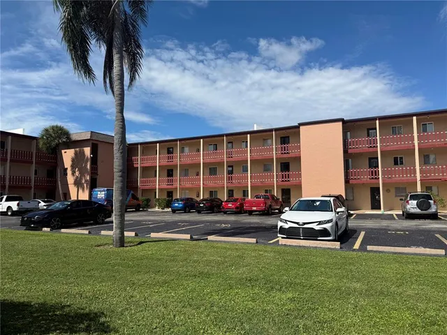 a car parked in front of a house with wooden fence