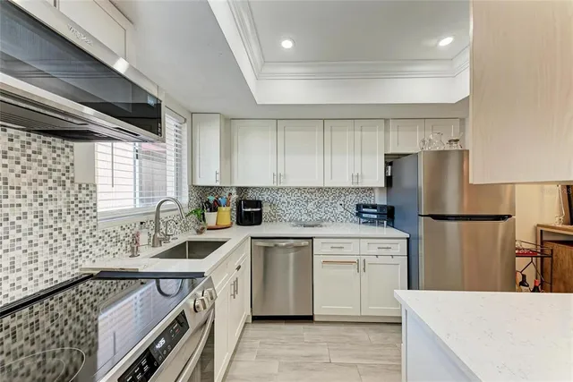 a view of a dining room with furniture and a chandelier