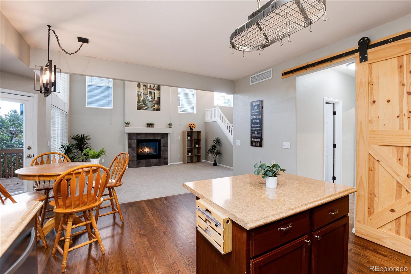 9218 Fox Fire Lane Highlands Ranch, CO 80129 - Photo 14 of 38 a view of kitchen island with furniture and wooden floor
