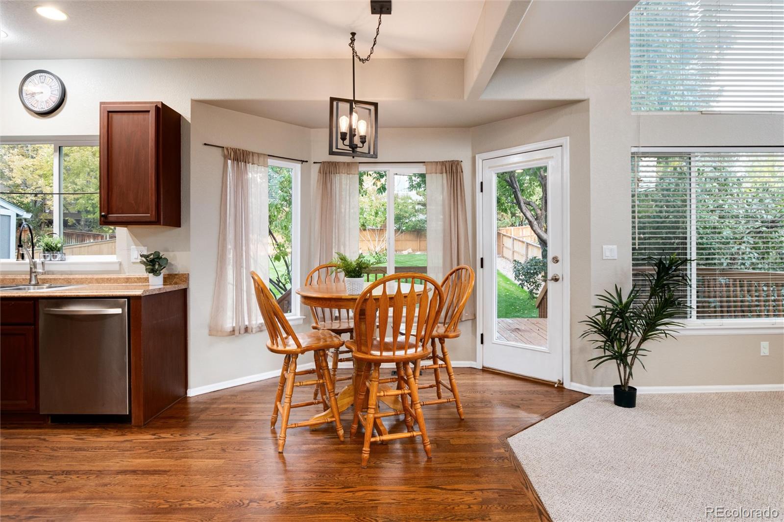 9218 Fox Fire Lane Highlands Ranch, CO 80129 - Photo 16 of 38 a view of a dining room with furniture window and wooden floor
